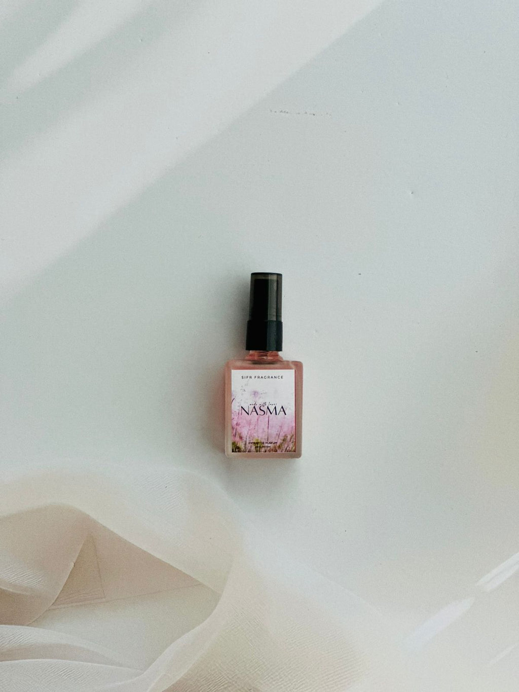 Nasma perfume with pear, jasmine, and vanilla orchid notes