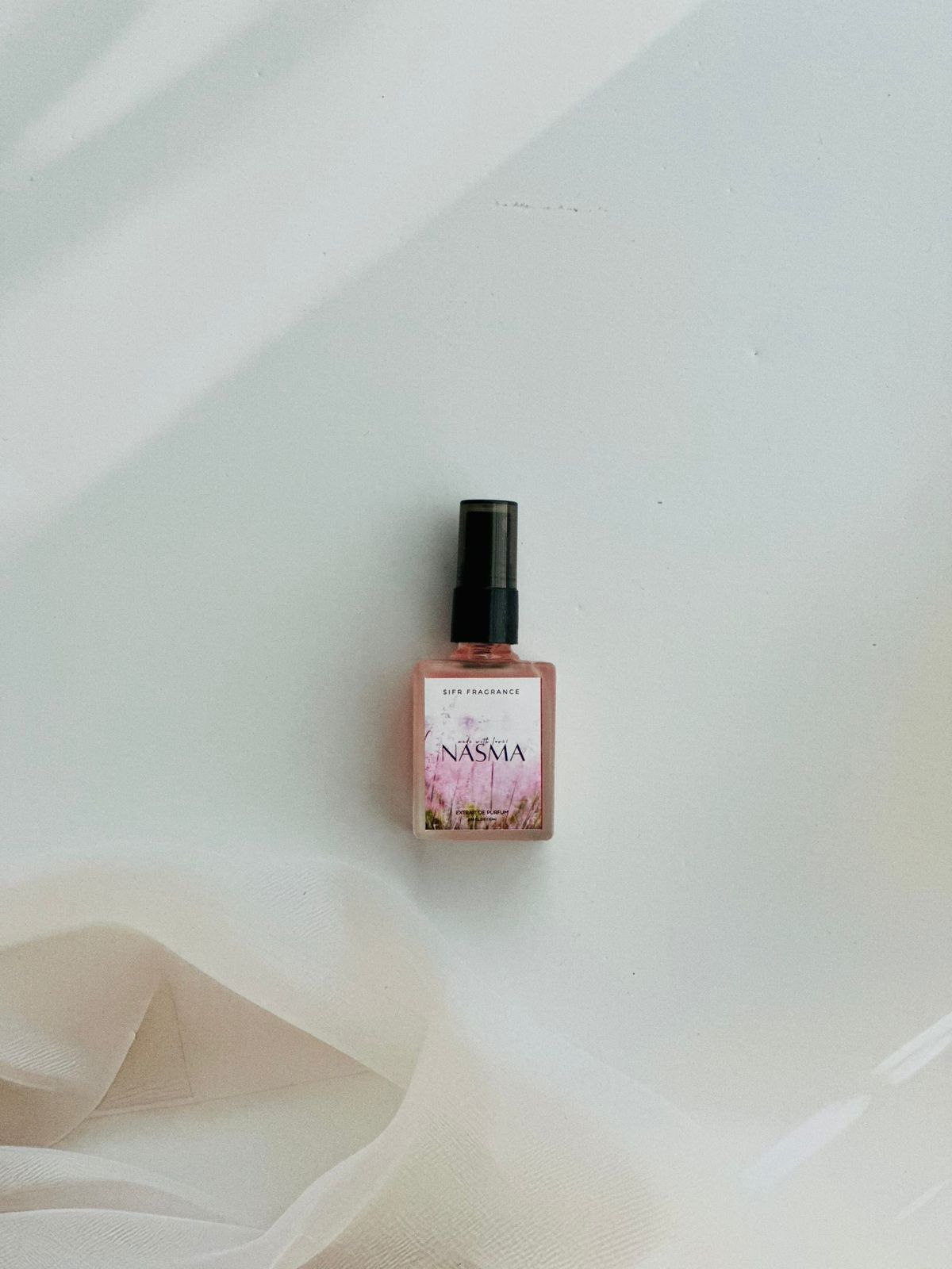 Nasma perfume with pear, jasmine, and vanilla orchid notes