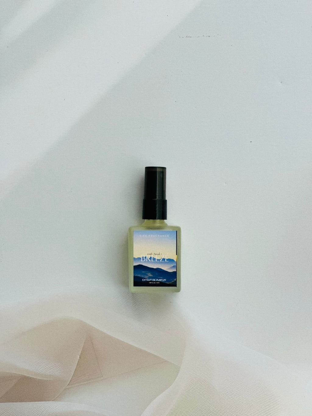 Breeze perfume bottle with bergamot, pineapple, and musk notes