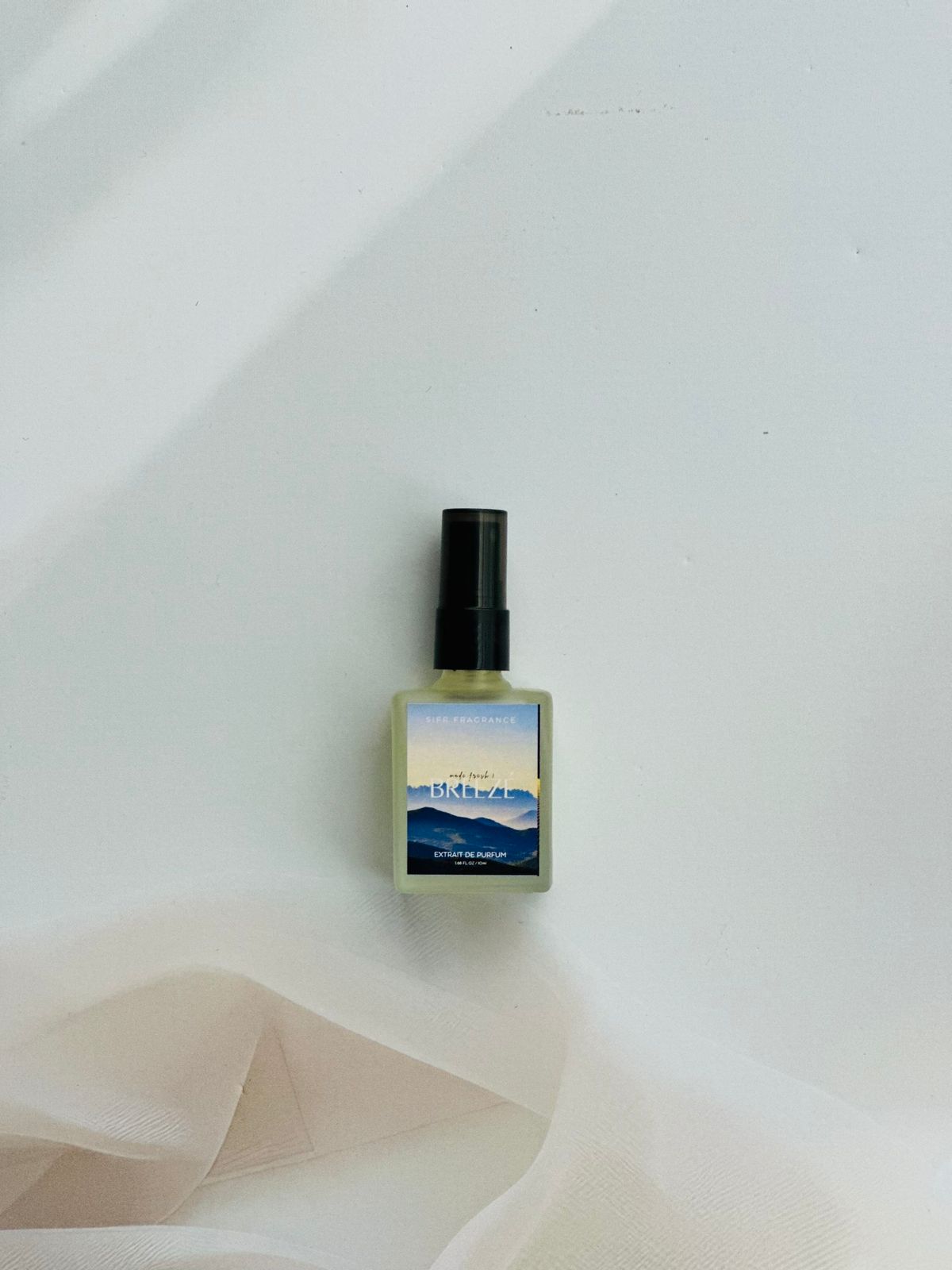 Breeze perfume bottle with bergamot, pineapple, and musk notes